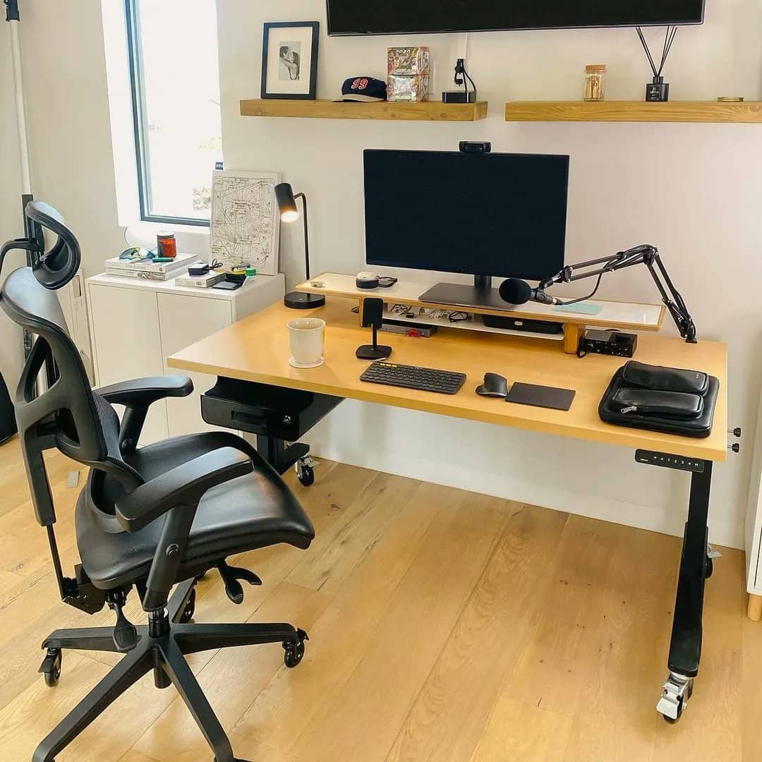 a standing desk with an ergonomic chair